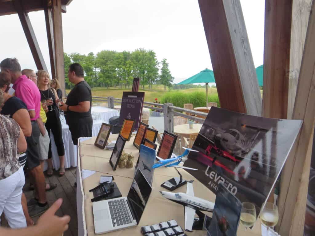 Attendees viewing Levaero display at Georgian Bay Club Foundation fundraiser.