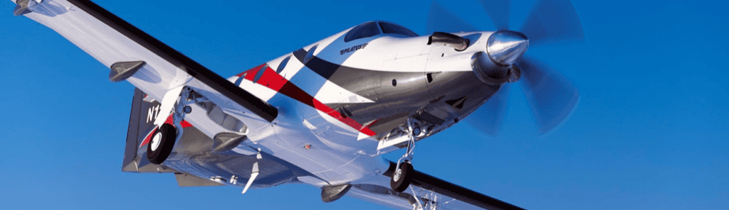 Levaero single turboprop aircraft flying in clear blue sky.