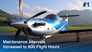 Pilatus PC-12 NGX aircraft on runway with mountains in background.