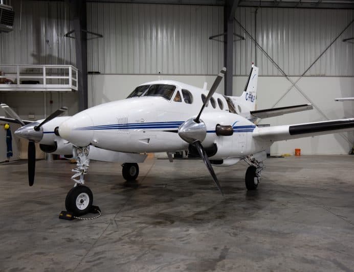 Vintage Beechcraft King Air C90 aircraft in a hangar.