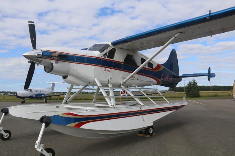 De Havilland Beaver DHC-2T seaplane on tarmac with floats and high wings.