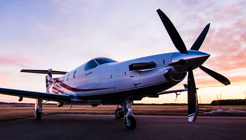Pilatus PC-12 NG aircraft at sunset, showcasing sleek design and advanced features.