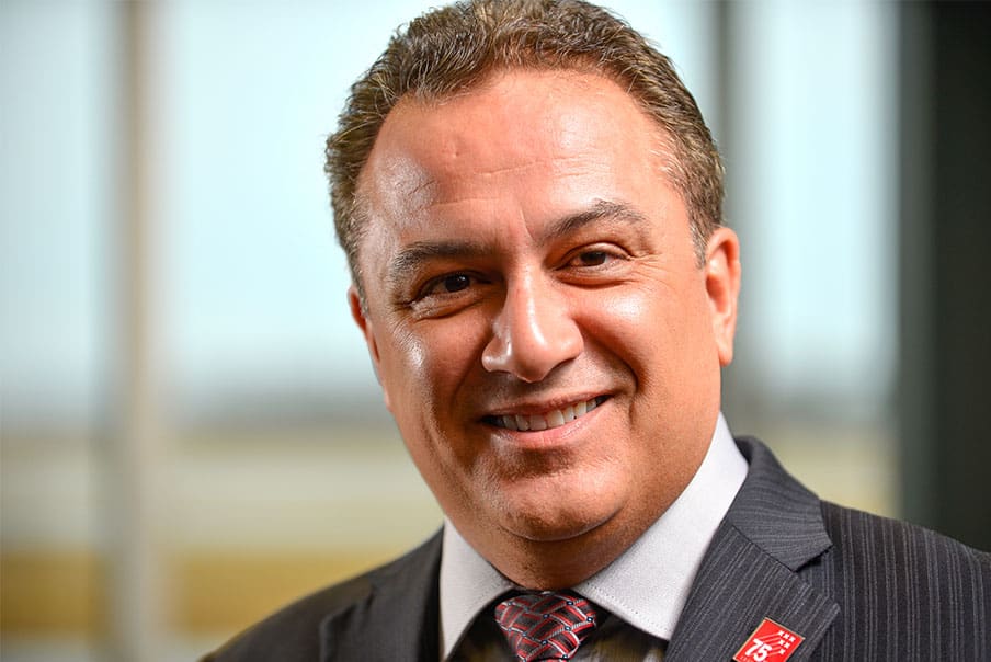 Professional business portrait of a smiling man in a suit at Levaero.