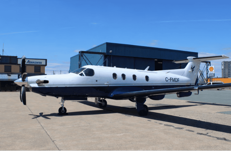 Pilatus PC-12 NG aircraft parked on tarmac at airport.