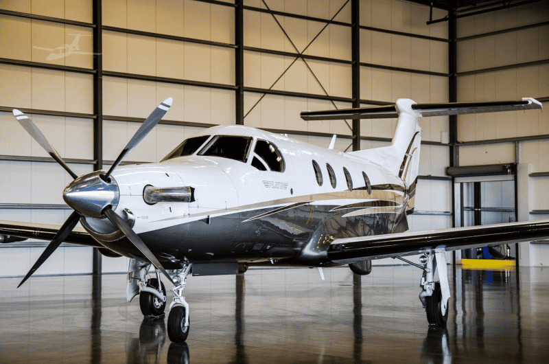 Aircraft image showing a 2006 Pilatus PC-12/47 in a spacious hangar.