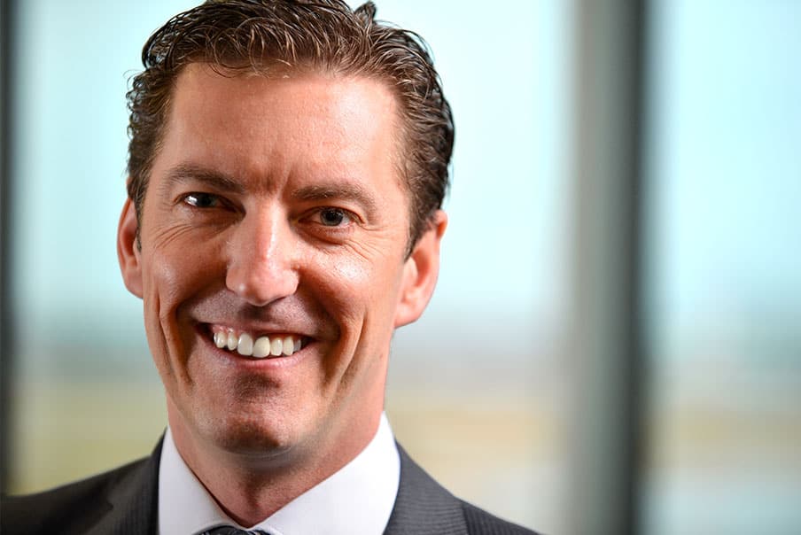 Professional man in business suit smiling, about Levaero.