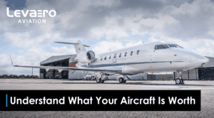 Modern private jet parked on tarmac, showcasing aircraft value factors.