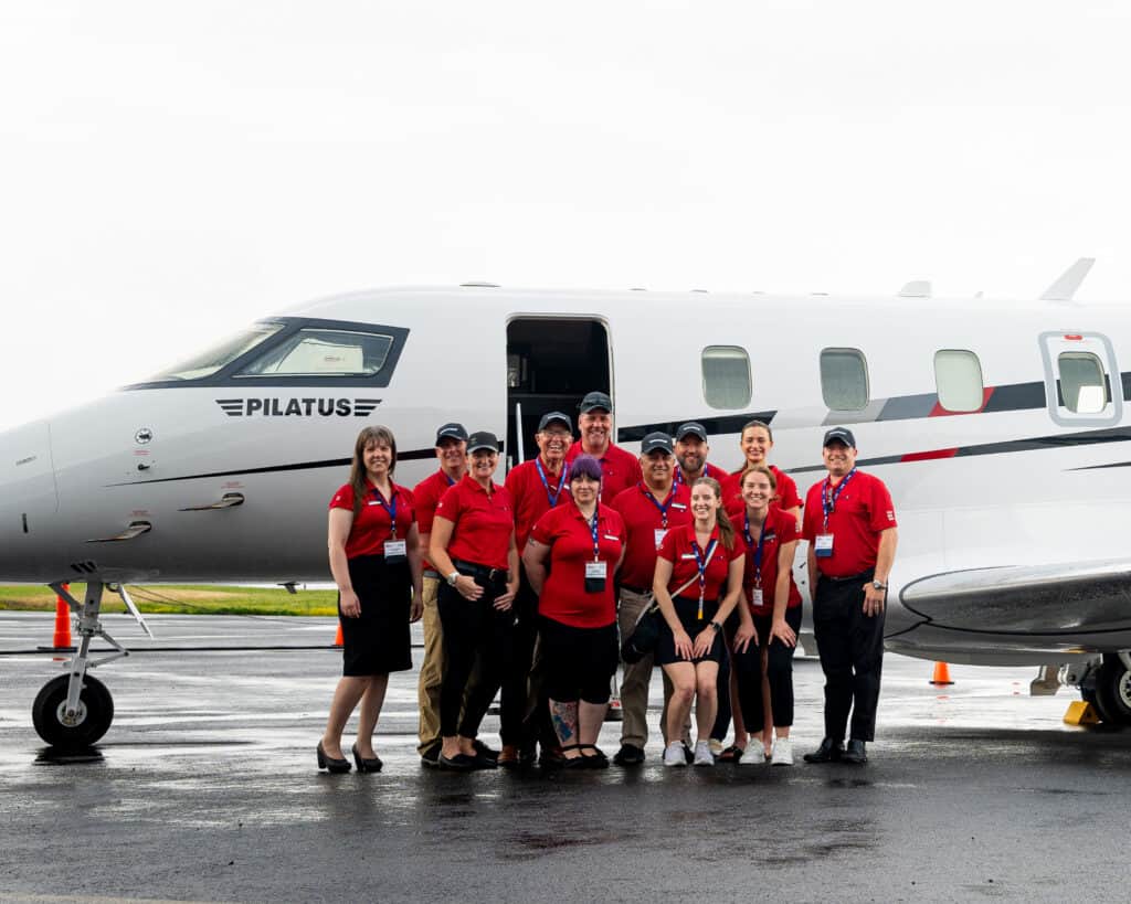 Levaero aviation careers team standing in front of a private jet.