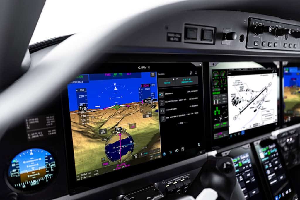 High-tech avionics screens showing navigation and flight data in an aircraft cockpit.